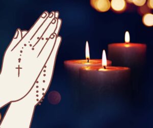 praying hands with candles